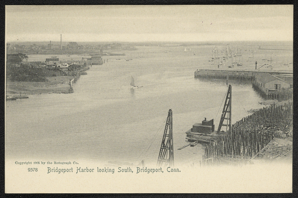 1905 postcard of Bridgeport harbor showing wharves, boats, industrial waterfront buildings and cranes