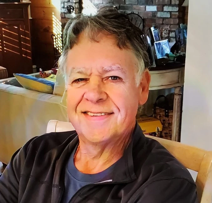 Edward ‘Big Ed’ McPadden smiling, seated indoors.